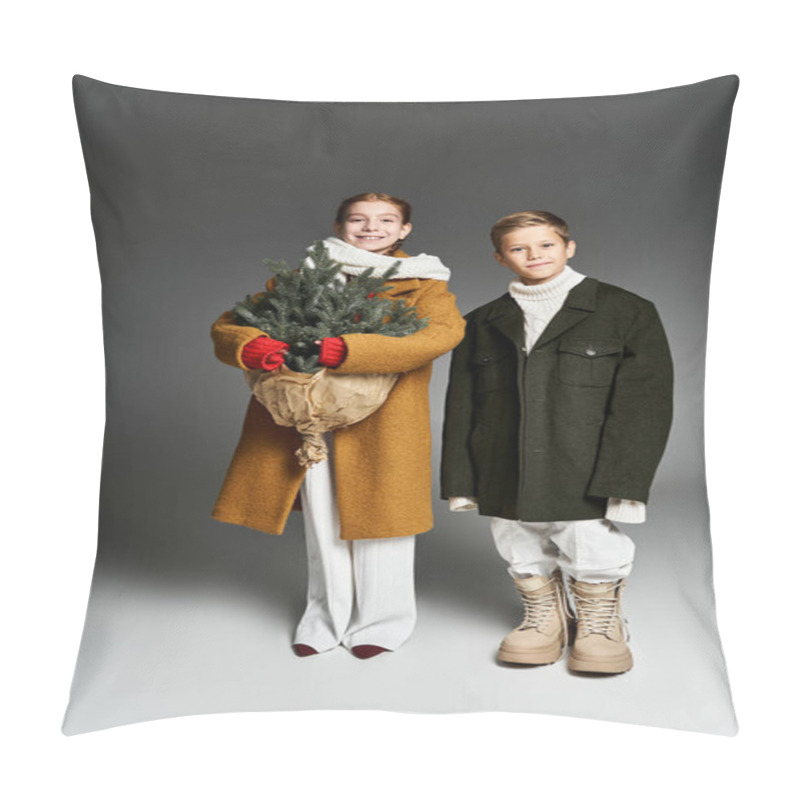 Personality  Two Children Dressed Warmly Hold A Small Christmas Tree, Radiating Festive Joy Indoors. Pillow Covers