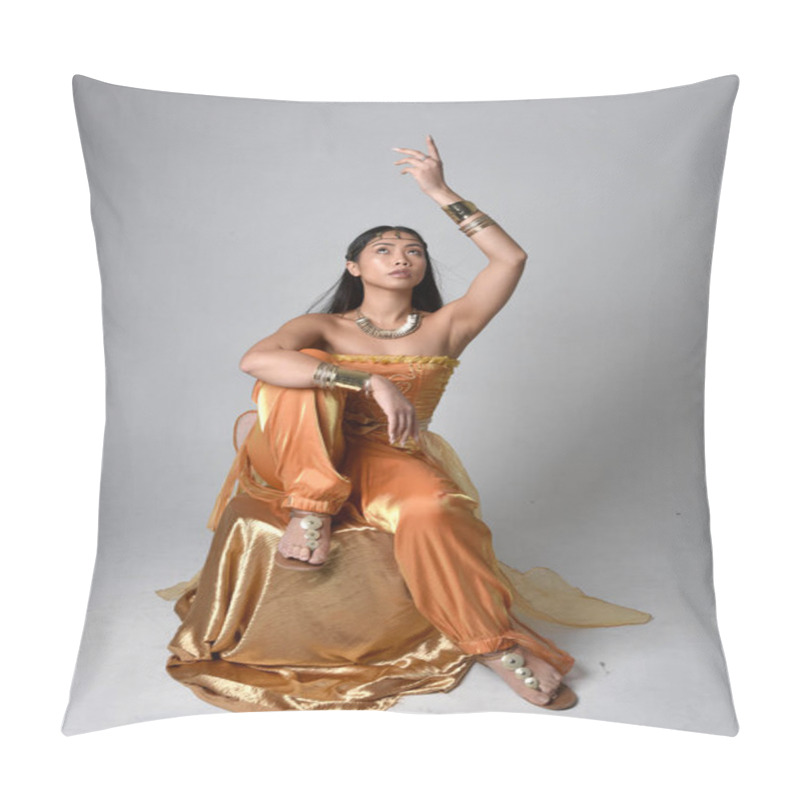 Personality  Full Length Portrait Of Pretty Young Asian Woman Wearing Golden Arabian Robes Like A Genie, Seated Pose, Isolated On Studio Background. Pillow Covers