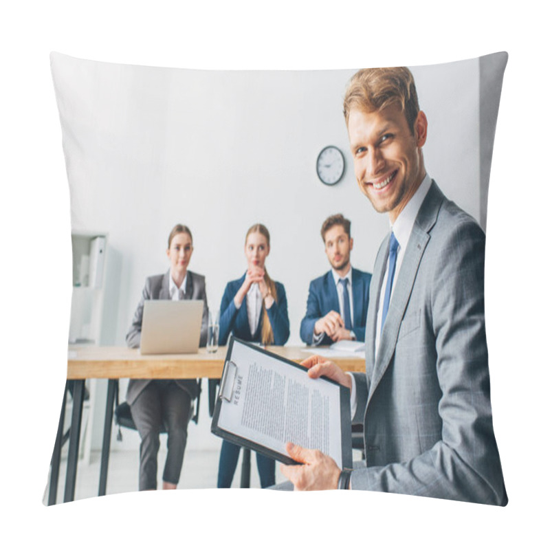 Personality  Selective Focus Of Smiling Employee With Resume Looking At Camera Near Recruiters In Office  Pillow Covers