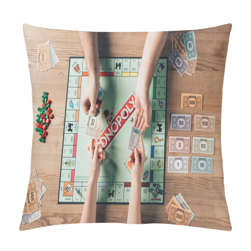 Personality  KYIV, UKRAINE - NOVEMBER 15, 2019: Cropped View Of Man And Woman Playing Monopoly Game At Table Pillow Covers