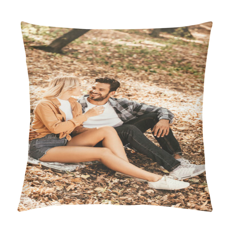 Personality  Happy Young Couple Looking At Each Other While Sitting On Fall Foliage In Park Pillow Covers