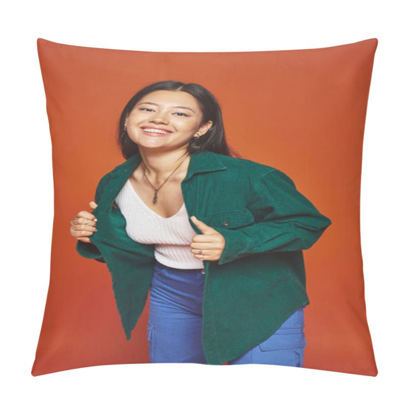 Personality  Radiant Young Asian Girl Posing In Vibrant Outfit And Wearing Green Jacket On Orange Background Pillow Covers