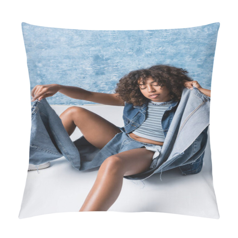 Personality  Trendy African American Woman In Torn Jeans Sitting On Floor With Closed Eyes On Blue Background Pillow Covers