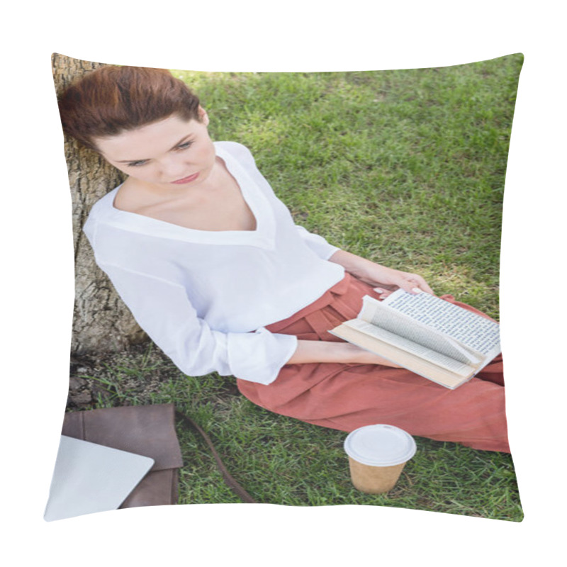 Personality  High Angle View Of Beautiful Young Woman With Book Leaning Back On Tree Trunk In Park Pillow Covers