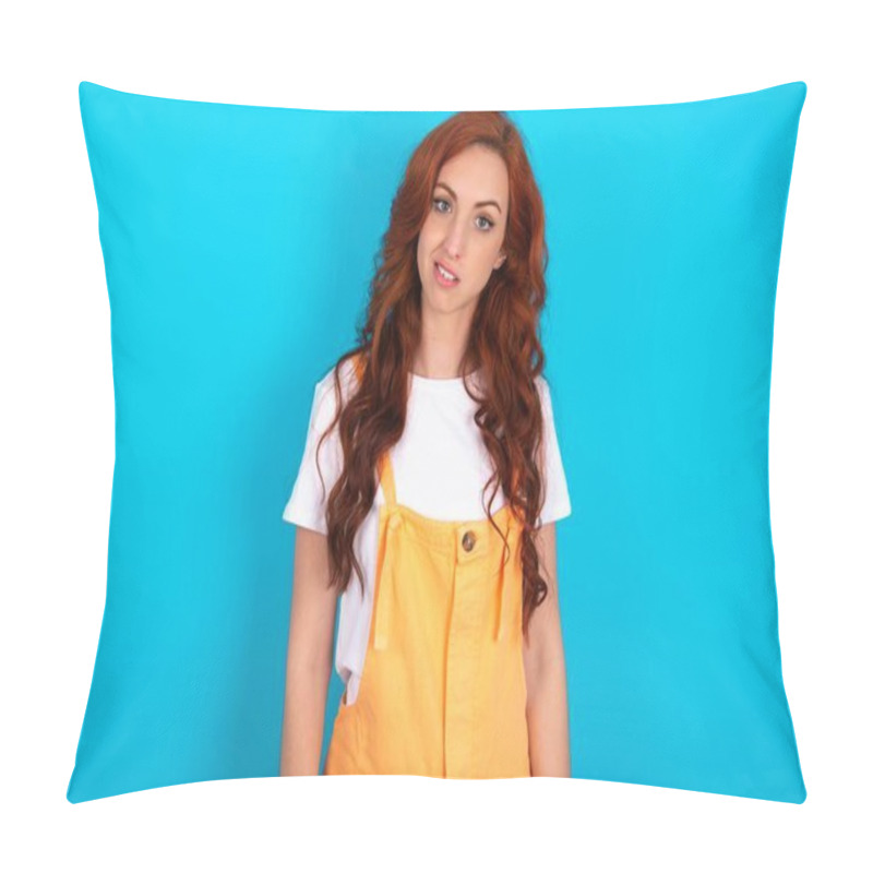 Personality  Portrait Of Dissatisfied Redhead Woman Wearing Orange Overall Over Blue Background Smirks Face, Purses Lips And Looks With Annoyance At Camera, Discontent Hearing Something Unpleasant Pillow Covers