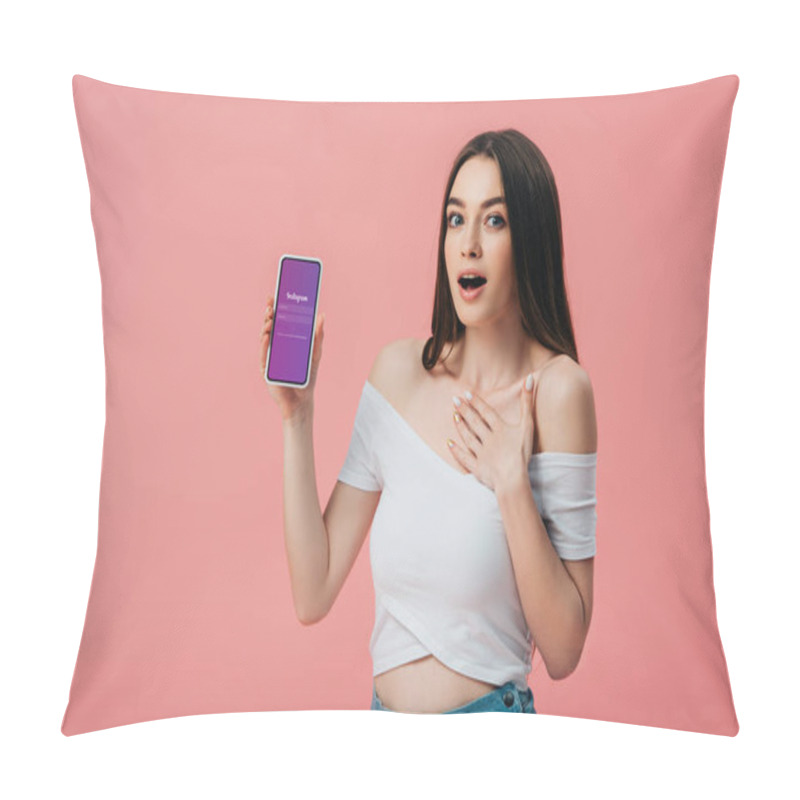 Personality  KYIV, UKRAINE - JUNE 6, 2019: Beautiful Shocked Girl Holding Smartphone With Instagram App Isolated On Pink Pillow Covers