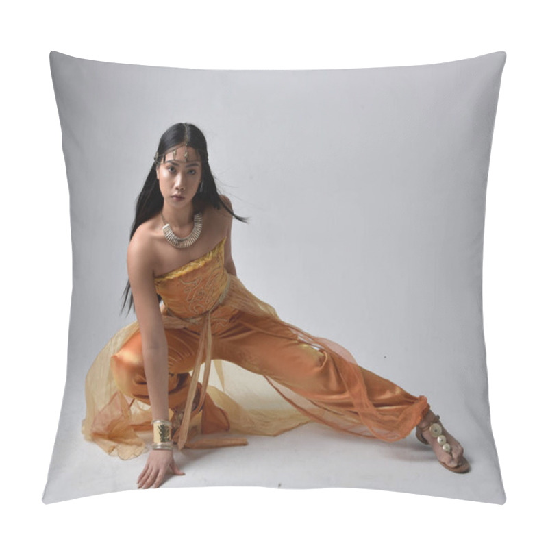 Personality  Full Length Portrait Of Pretty Young Asian Woman Wearing Golden Arabian Robes Like A Genie, Seated Pose, Isolated On Studio Background. Pillow Covers