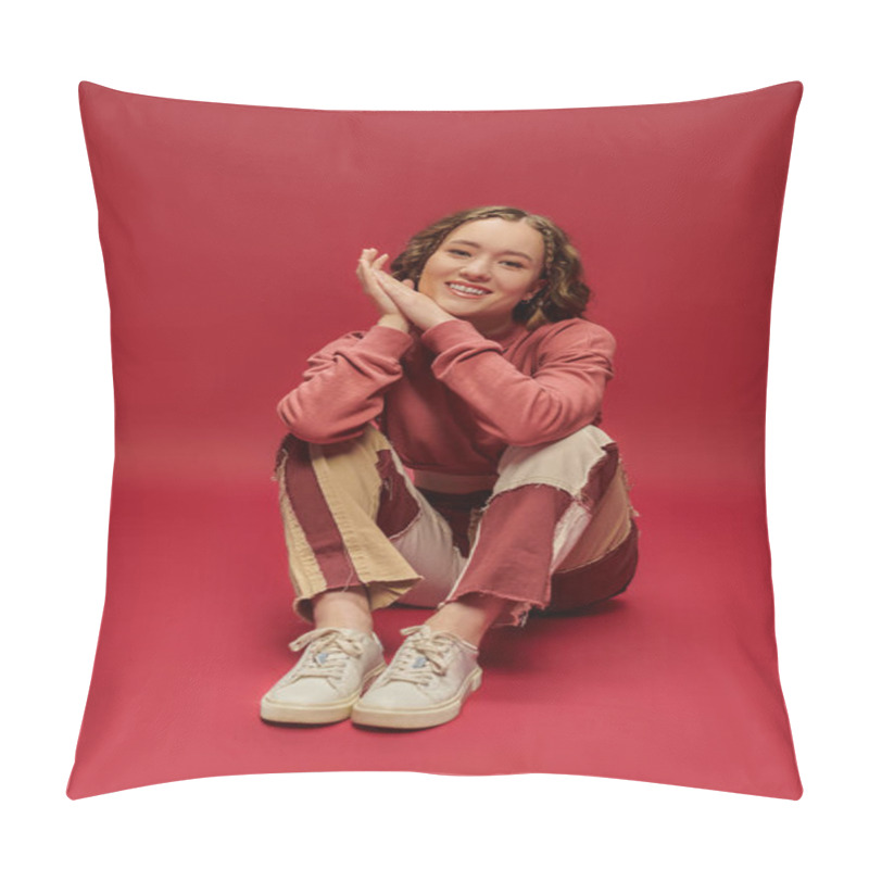 Personality  Joyful Woman In Patchwork Pants And Cropped Long Sleeve Sitting On Red Backdrop, Youth Culture Pillow Covers