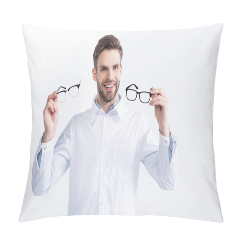 Personality  Front View Of Smiling Ophthalmologist Showing Pair Of Eyeglasses, While Looking At Camera Isolated On White Pillow Covers