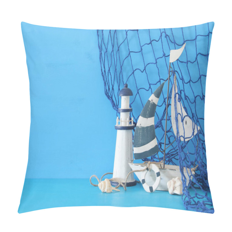 Personality  Nautical Concept With White Decorative Sail Boat, Lighthouse, Seashells And Fishnet Over Blue Wooden Table And Background. Pillow Covers