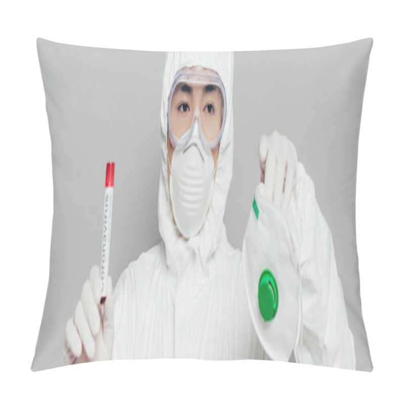 Personality  Panoramic Shot Of Asian Epidemiologist Showing Respirator Mask And Test Tube With Blood Sample Isolated On Grey Pillow Covers