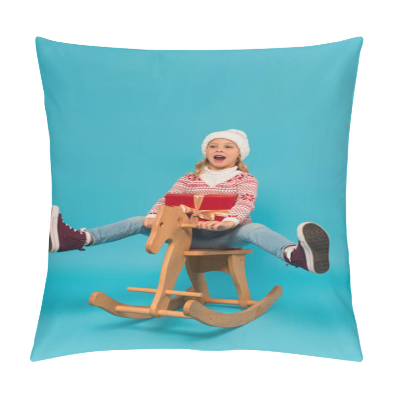 Personality  Cheerful Girl In Warm Hat Shouting While Riding Rocking Horse With Gift Box On Blue Pillow Covers