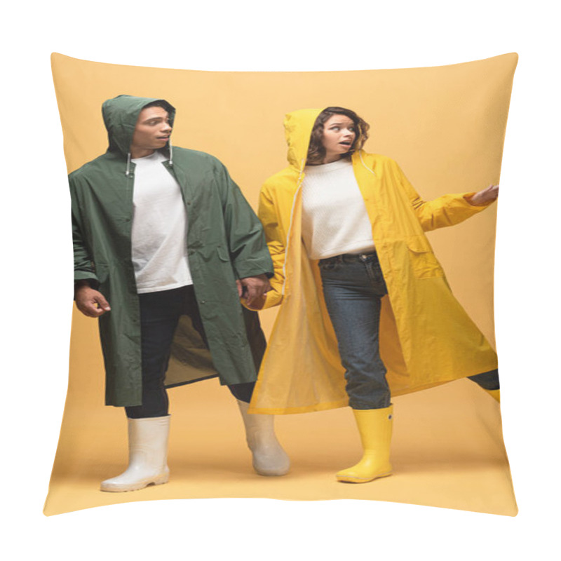 Personality  Surprised Interracial Couple In Raincoats And Rubber Boots On Yellow Background Pillow Covers