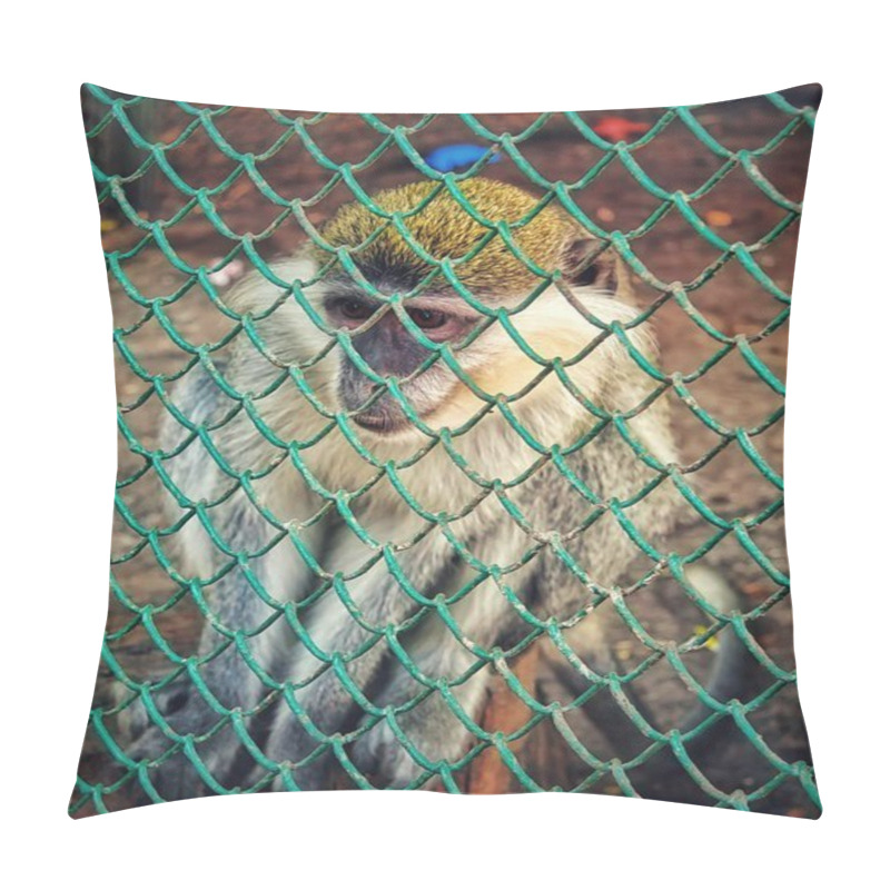 Personality  A Monkey Is Seen Behind The Bars Of A Metal Cage. The Animal Is Looking Out, With Its Expressive Eyes And Curious Posture. The Blurred Background Draws Attention To The Monkey's Face. Pillow Covers