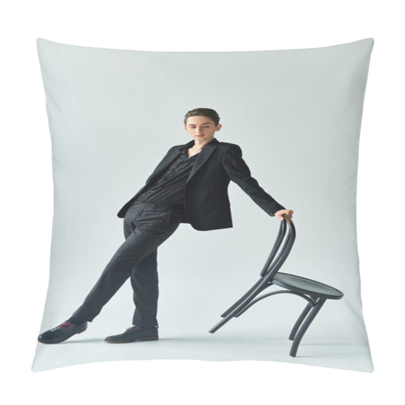 Personality  A Young Queer Person In A Black Suit Leans Elegantly On A Black Chair, Striking A Confident And Stylish Pose In A Studio. Pillow Covers