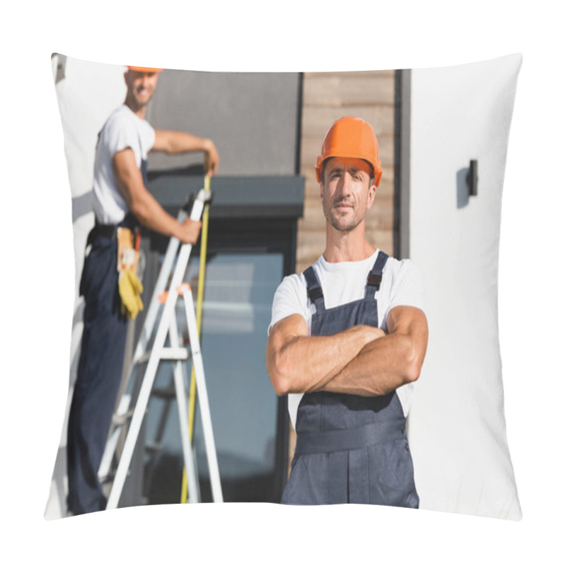 Personality  Selective Focus Of Builder With Crossed Arms Looking At Camera With Colleague And Building At Background  Pillow Covers