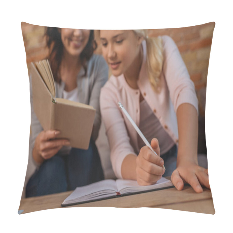 Personality  Selective Focus Of Smiling Woman Holding Book Near Child Writing On Notebook At Home  Pillow Covers