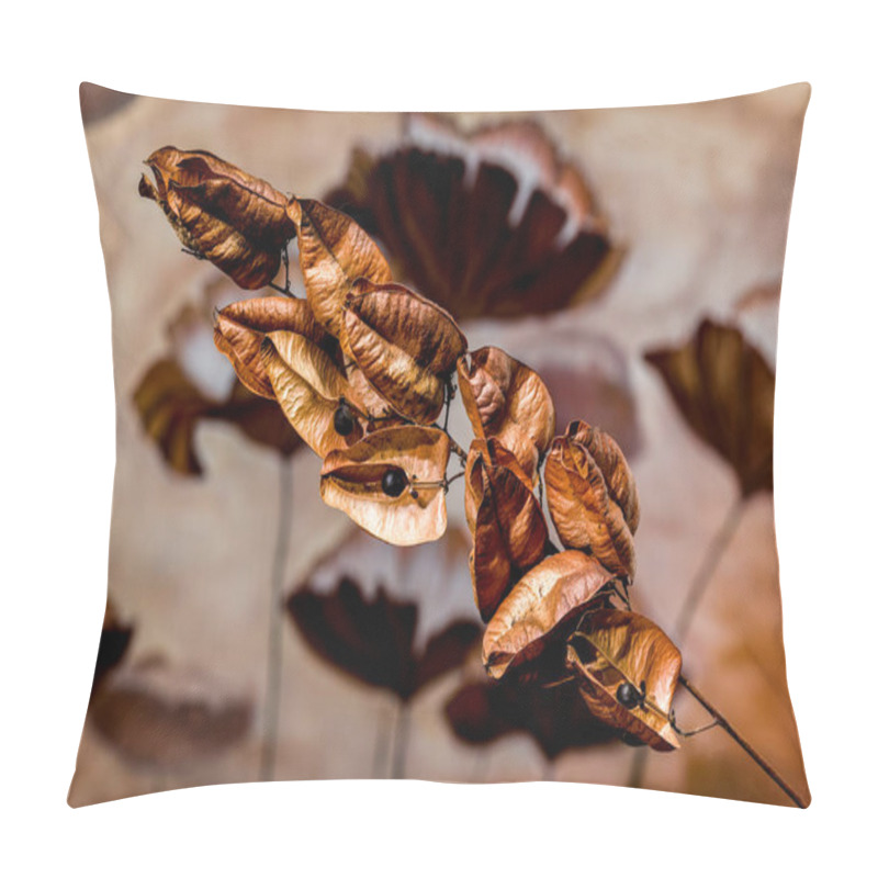 Personality  A Close-up Of Dry, Golden-brown Seed Pods With Small Black Berries, Set Against A Blurred, Earthy-toned Background With Soft Floral Patterns Pillow Covers