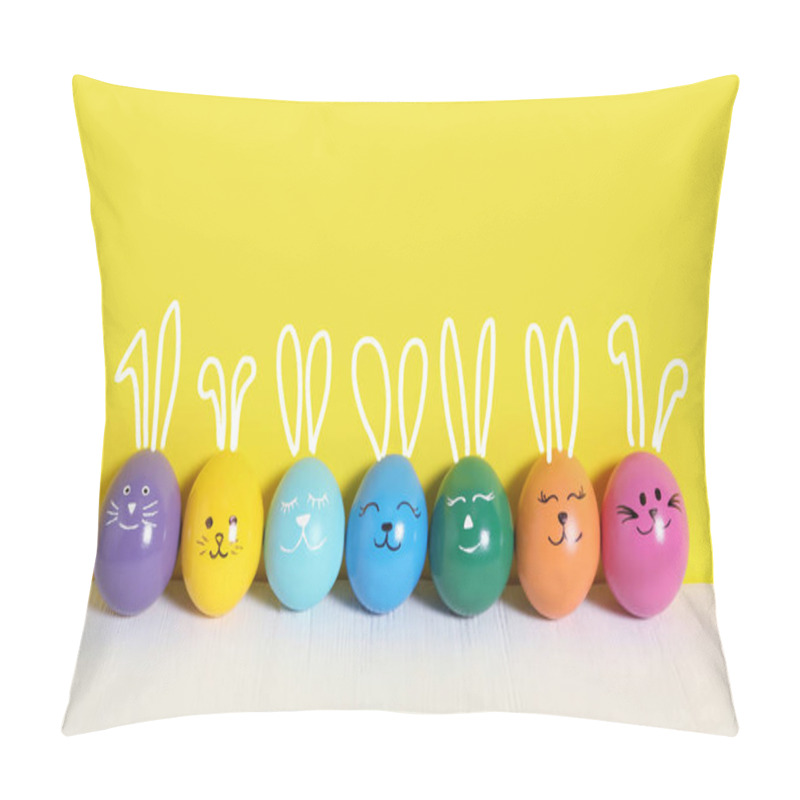 Personality  Colorful Eggs With Drawn Faces And Ears As Easter Bunnies On White Wooden Table Against Yellow Background Pillow Covers