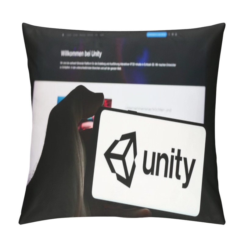 Personality  Stuttgart, Germany - 08-09-2024: Person Holding Smartphone With Logo Of US Video Games Company Unity Software Inc. In Front Of Website. Focus On Phone Display. Pillow Covers