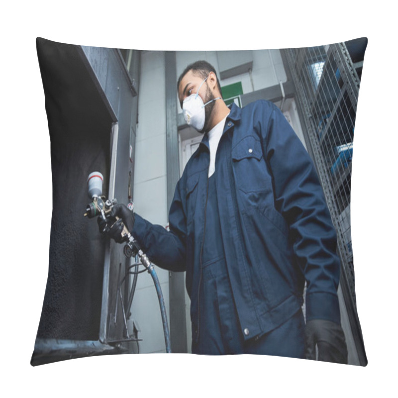 Personality  Young Mechanic Focused On His Task While Spray Painting Equipment In A Busy Workshop. Pillow Covers