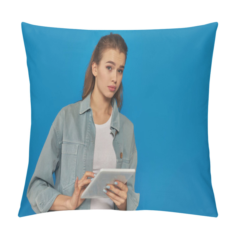 Personality  Beautiful Young Woman Holding Digital Tablet And Looking At Camera On Blue Backdrop, Confused Face Pillow Covers