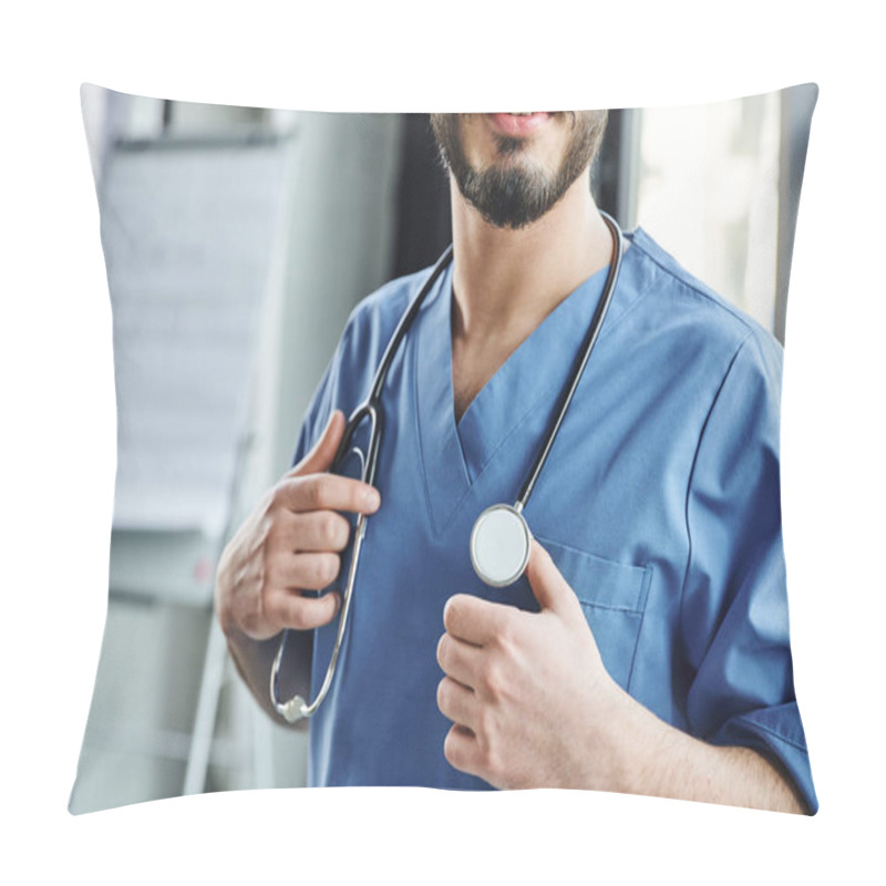 Personality  Cropped View Of Positive Bearded Doctor In Blue Uniform Touching Stethoscope On Neck While Standing In Training Room, First Aid Training Seminar And Emergency Preparedness Concept Pillow Covers