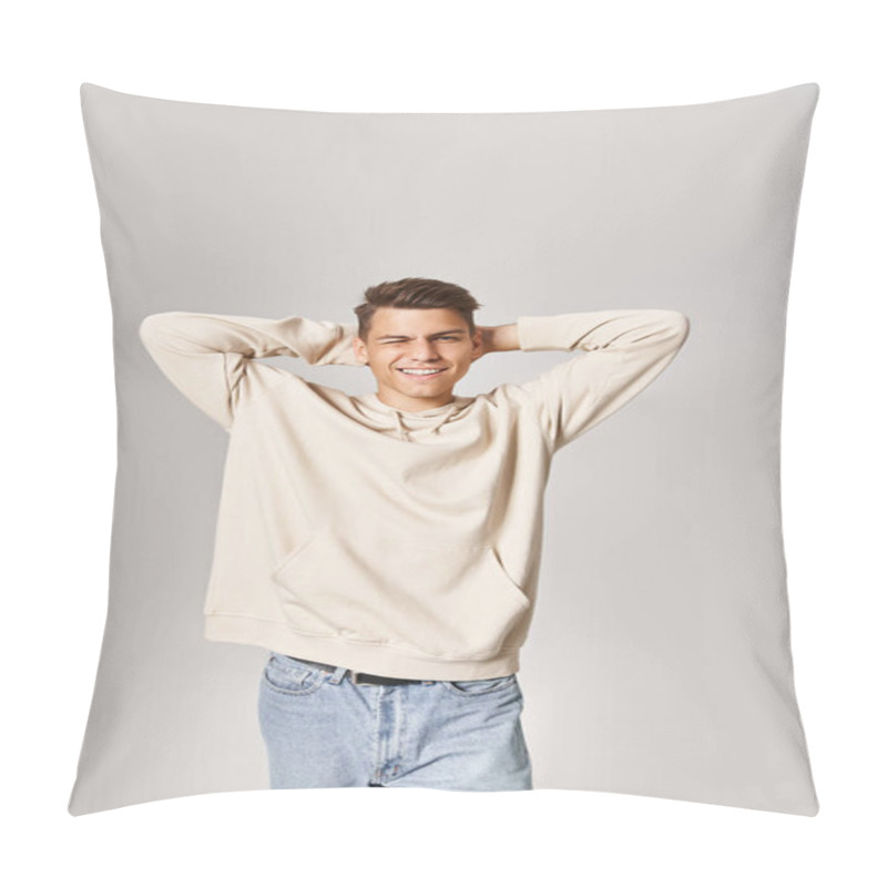 Personality  Charming Guy In White Hoodie Putting Hands Behind Head And Winking To Camera On Light Background Pillow Covers