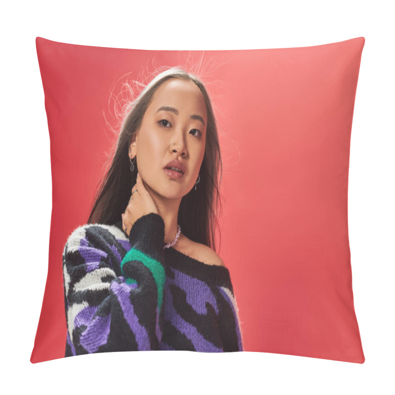 Personality  Young Pretty Asian Woman In Sweater With Animal Print Touching Neck While Posing On Red Backdrop Pillow Covers