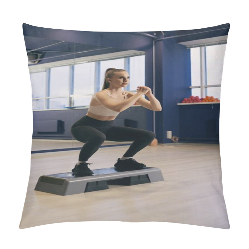 Personality  A Woman In Athletic Wear Completes Squats On A Step Platform In A Well-lit Fitness Studio. The Environment Is Designed For Exercise, With Colorful Weights Visible In The Background. Pillow Covers