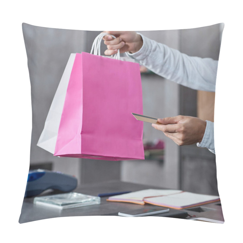 Personality  Cropped Shot Of Salesman Holding Paper Bags And Credit Card In Shop Pillow Covers