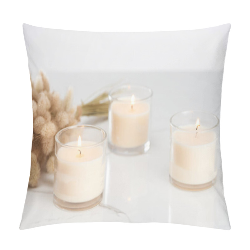 Personality  Selective Focus Of Fluffy Bunny Tail Grass And Burning White Candles In Glass Glowing On Marble White Surface Pillow Covers