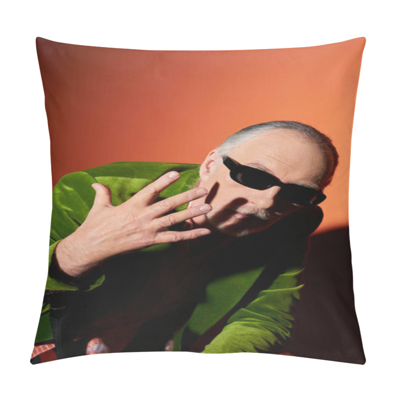 Personality  Expressive Senior Male Model In Dark Sunglasses And Green Velour Blazer Gesturing With Hand Near Face And Looking At Camera On Red And Orange Background With Shadow, Vibrant Aging Personality Pillow Covers