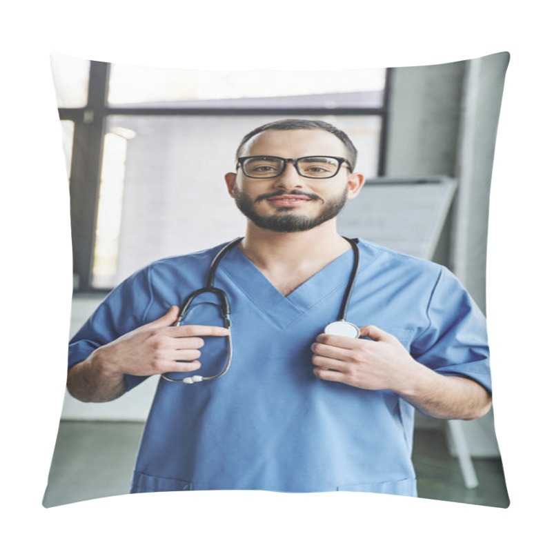 Personality  Cheerful Bearded Healthcare Worker With Radiant Smile Standing In Blue Uniform And Touching Stethoscope On Neck In Clinic, First Aid Training Seminar And Emergency Preparedness Concept Pillow Covers