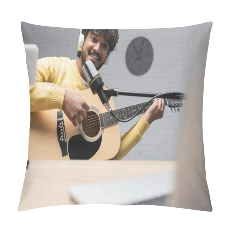 Personality  Smiling Indian Broadcaster In Wireless Headphones Playing Acoustic Guitar During Performance Near Microphone And Blurred Laptop On Table In Studio  Pillow Covers