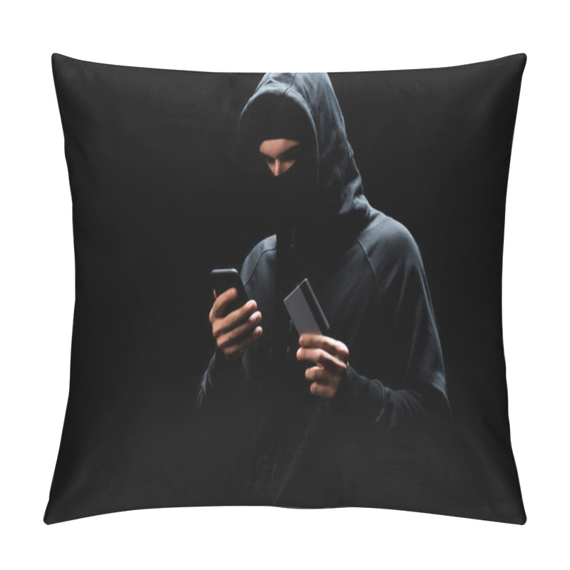 Personality  Hacker In Mask Using Smartphone And Holding Credit Card Isolated On Black  Pillow Covers