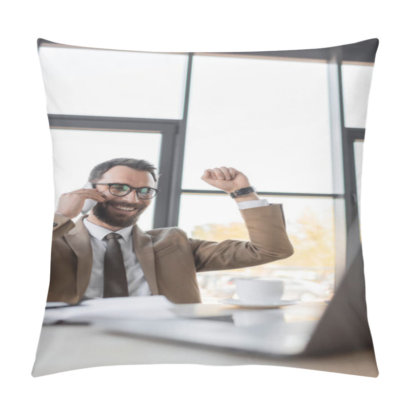 Personality  Overjoyed Bearded Manager In Stylish Business Attire Talking On Mobile Phone And Showing Win Gesture Near Cup Of Coffee And Computer On Blurred Foreground In Office  Pillow Covers