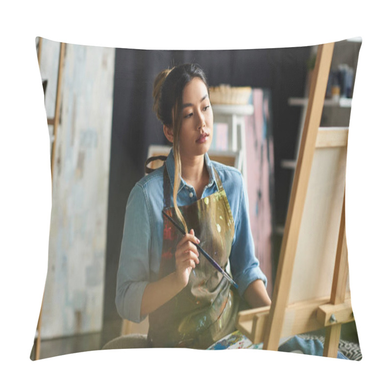 Personality  An Asian Artist In An Apron Stands In Her Studio, Thoughtfully Considering Her Next Brushstroke On A Canvas. Pillow Covers