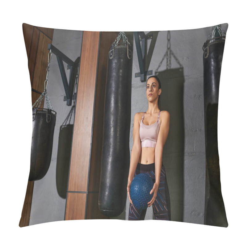 Personality  Woman Stands Determined While Holding A Weighted Ball, Ready For Her Exercise Routine In A Gym. Pillow Covers