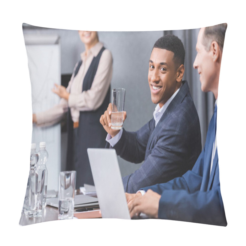 Personality  Smiling African American Businessman With Glass Of Water Looking At Camera While Sitting At Workplace On Blurred Background Pillow Covers