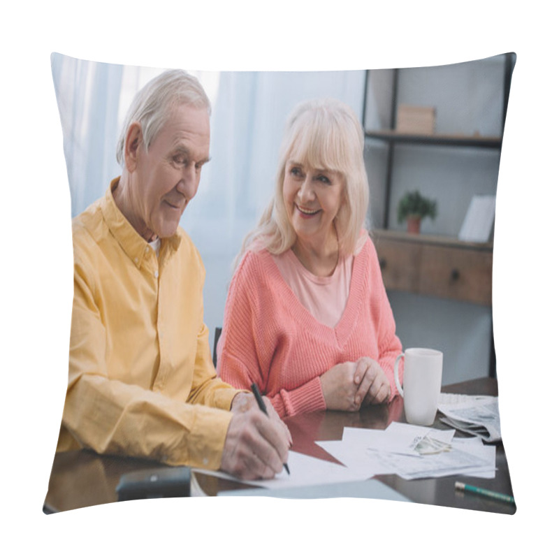 Personality  Happy Senior Couple Sitting At Table And Filling Documents At Home Pillow Covers