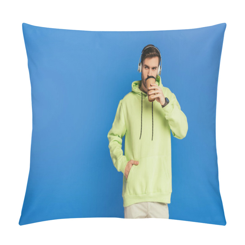 Personality  Dreamy Young Man In Wireless Headphones Drinking Coffee To Go And Looking Away Isolated On Blue Pillow Covers