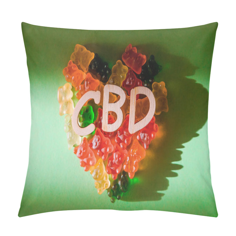 Personality  Photo Of Wooden Letters CBD On A Green Background And Bears Gelatin In The Form Of Heart. View From Above. The Shadow Of The Sun Falls On The Background. Top View Pillow Covers