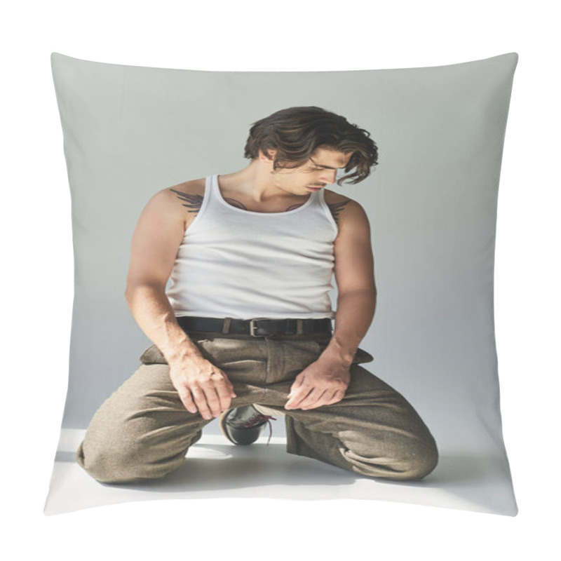 Personality  A Handsome Young Man Kneels In A Tank Top, Showcasing His Tattoo Against A Minimalist Grey Background. Pillow Covers