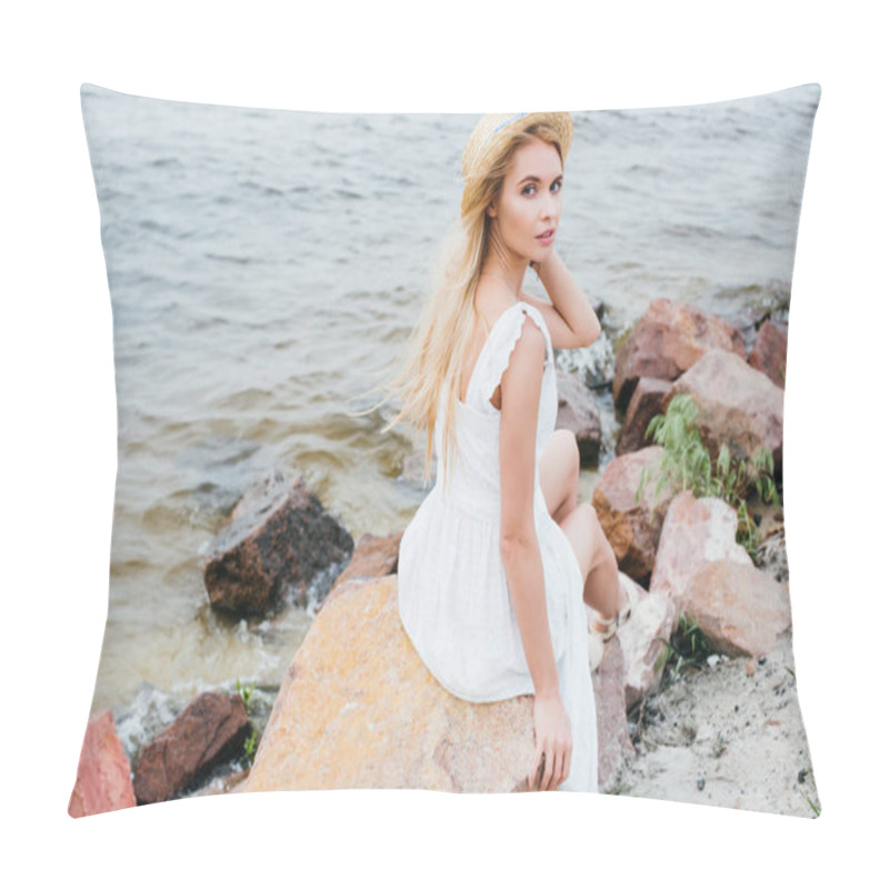 Personality  Beautiful Blonde Girl Touching Straw Hat While Sitting On Stones Near Sea Pillow Covers