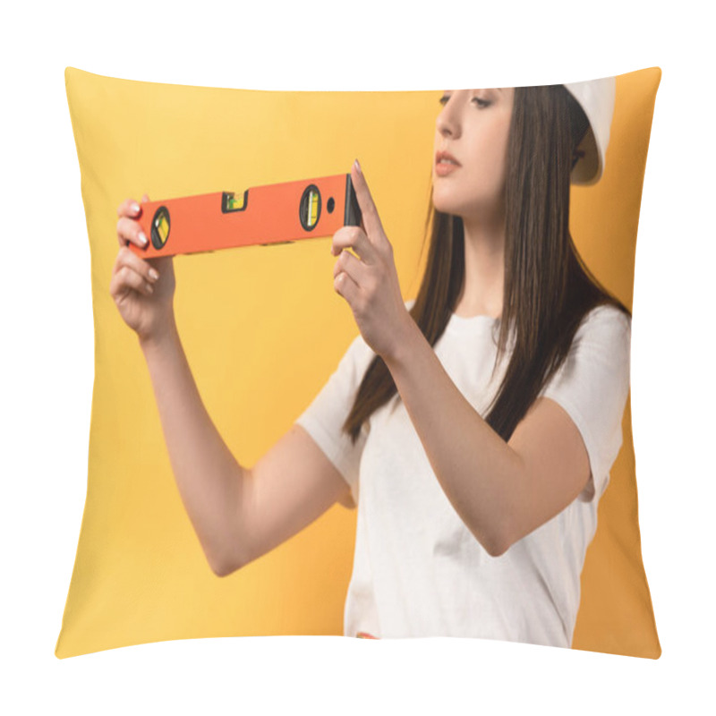 Personality  Cropped View Of Concentrated Handywoman Holding Spirit Level On Yellow Background  Pillow Covers