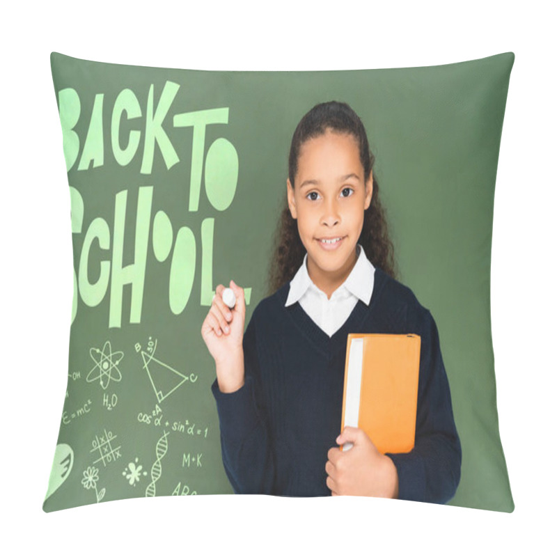 Personality  African American Schoolgirl Holding Piece Of Chalk And Book While Standing Near Chalkboard With Back To School Lettering Pillow Covers