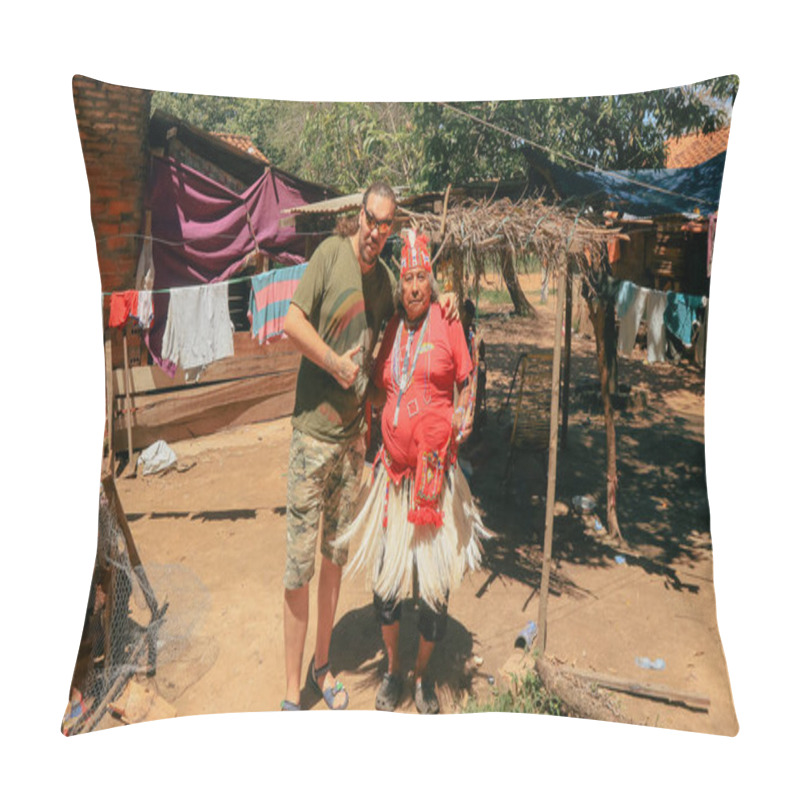 Personality  Asuncion, Paraguay - August 21, 2023: A Visitor Engages With A Local Wearing Vibrant Traditional Clothing Amidst A Rural Paraguay Setting, With Colorful Laundry Hanging Nearby And Simple Homes In The Background. Pillow Covers