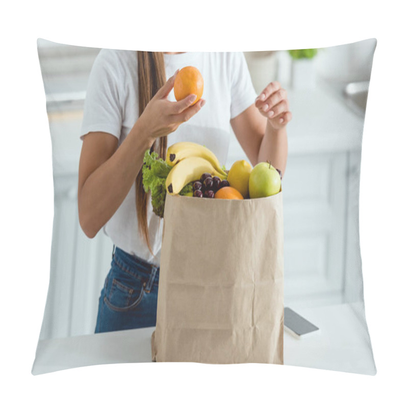 Personality  Cropped View Of Woman With Orange Near Paper Bag And Smartphone With Blank Screen Pillow Covers