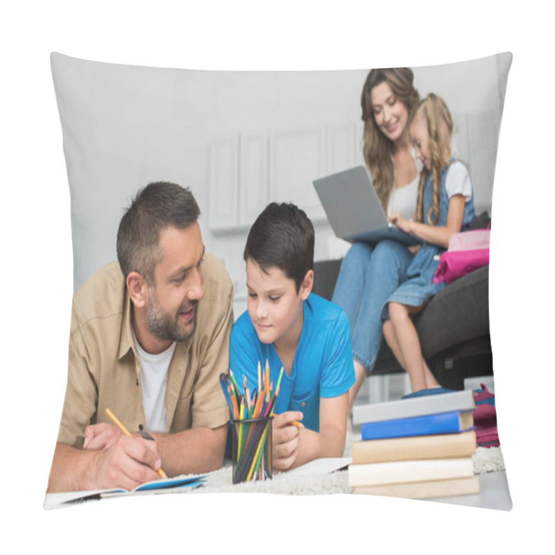 Personality  Selective Focus Of Man Helping Son With Homework While Mother And Daughter Using Laptop On Sofa Together At Home Pillow Covers